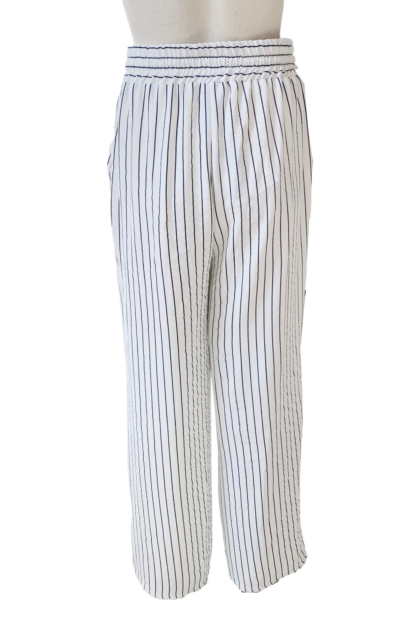A back view of The Concordia Pant by Pure Essence in Ivory Pinstripe is shown on a mannequin in front of a white background