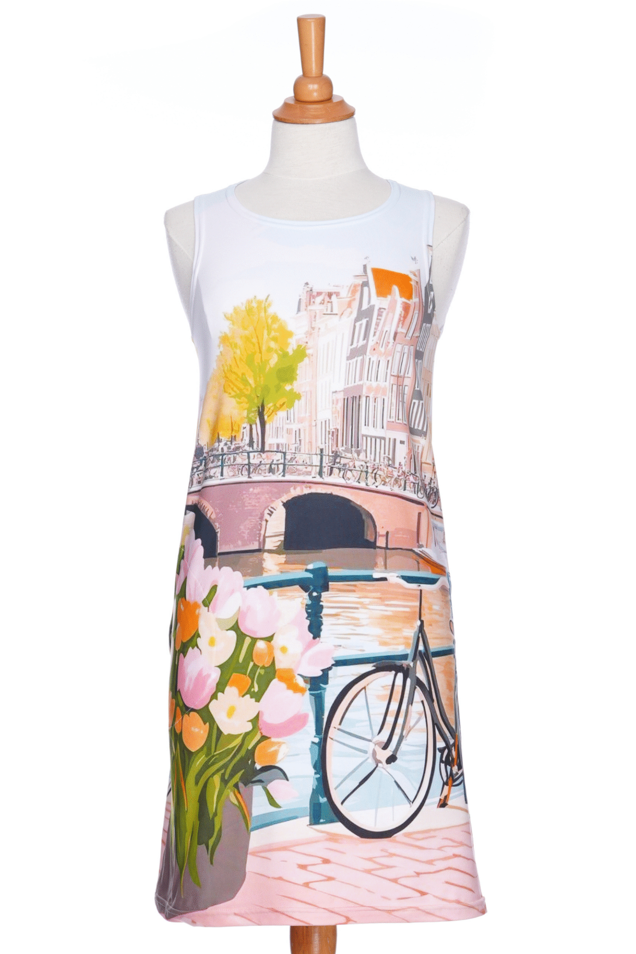 The Limoncello Dress by RNSP, a sleeveless above the knee dress with an Amstersdam landscape scene print, is shown on a mannequin in front of a white background. 