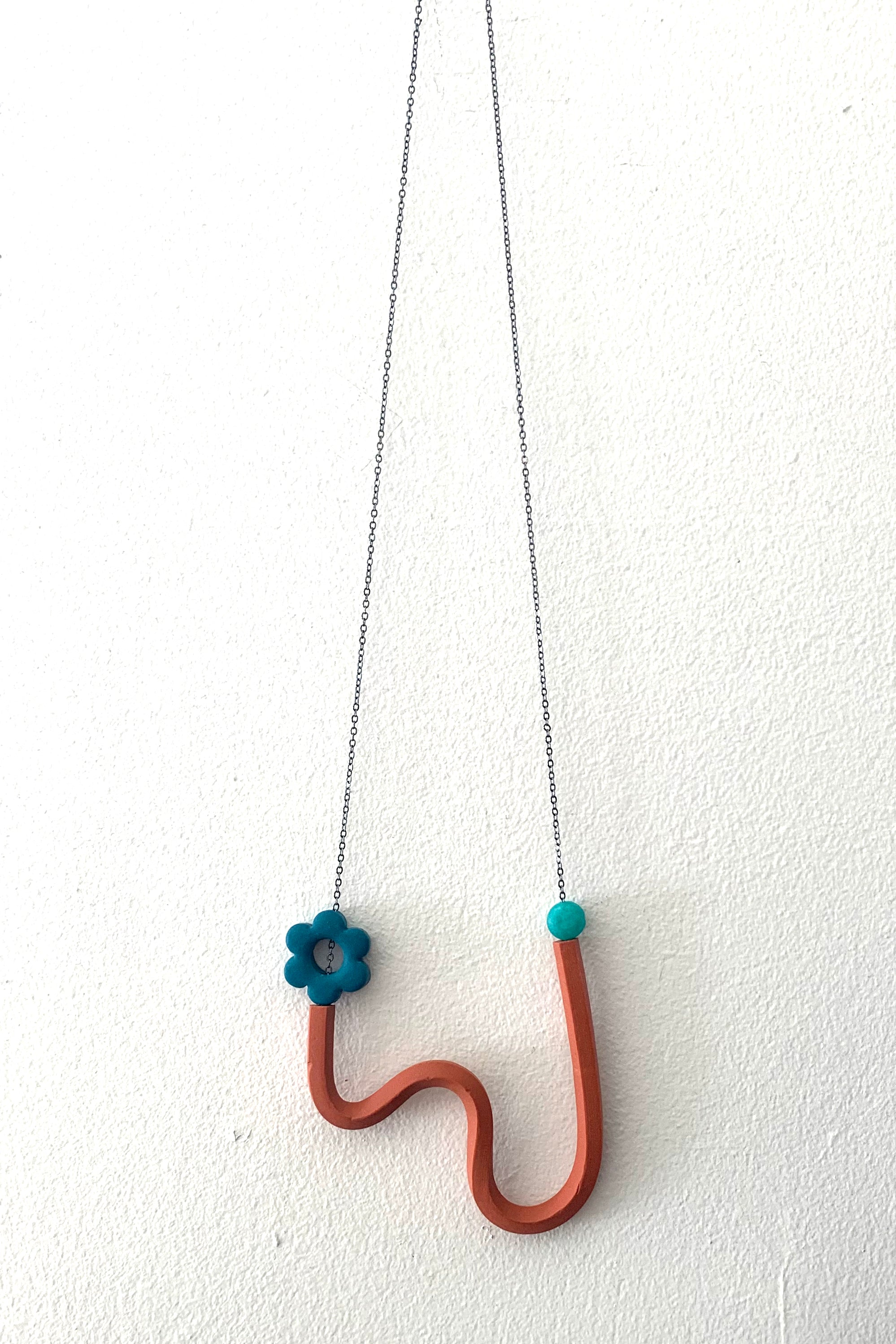 Terracotta Squiggle Necklace with Peacock Flower and transparent teal beads