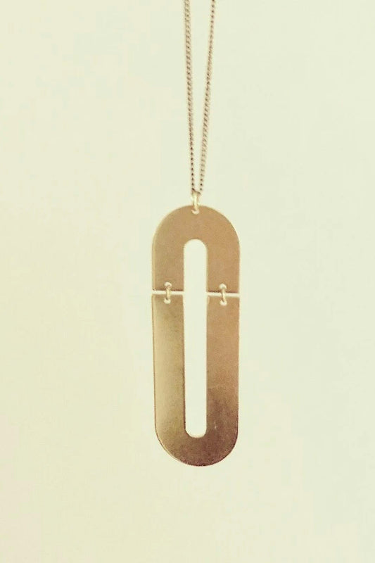 Trub long necklace by Darlings of Denmark; raw brass; double arch design; flat lay