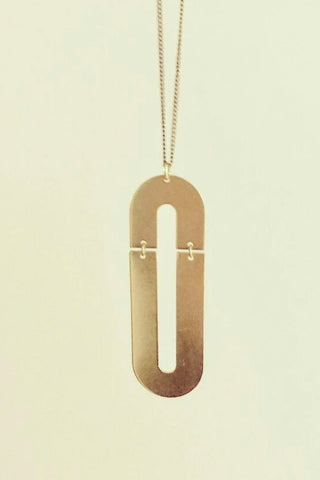 Trub long necklace by Darlings of Denmark; raw brass; double arch design; flat lay