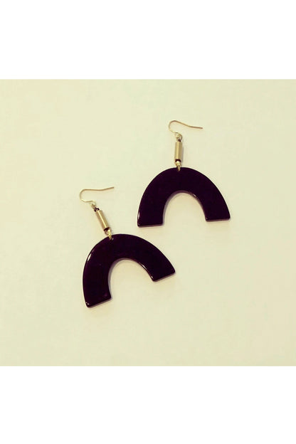 Vuttue dangle earring by Darlings of Denmark; black acrylic arch hanging off raw brass tubes; flat lay